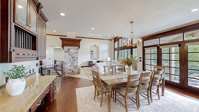 997 W 675 S, Mapleton, UT 84664 - dining space featuring arched walkways, dark wood-style flooring, french doors, recessed lighting, and a textured ceiling