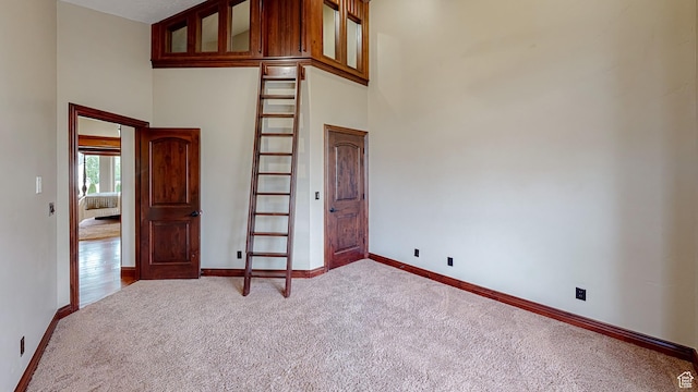 997 W 675 S, Mapleton, UT 84664 - empty room featuring carpet, a towering ceiling, and baseboards