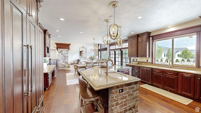 997 W 675 S, Mapleton, UT 84664 - kitchen featuring a sink, a textured ceiling, a chandelier, dark wood-style floors, and open floor plan