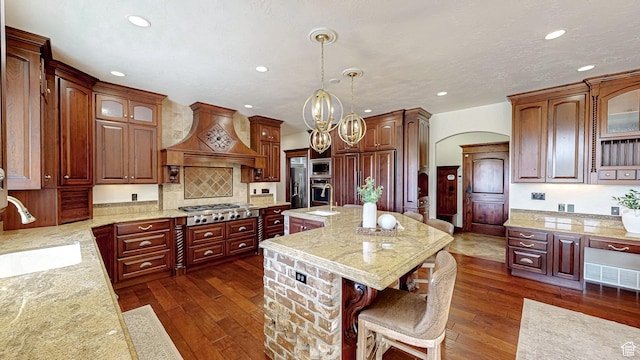 997 W 675 S, Mapleton, UT 84664 - kitchen with custom exhaust hood, built in appliances, a sink, recessed lighting, and a kitchen breakfast bar