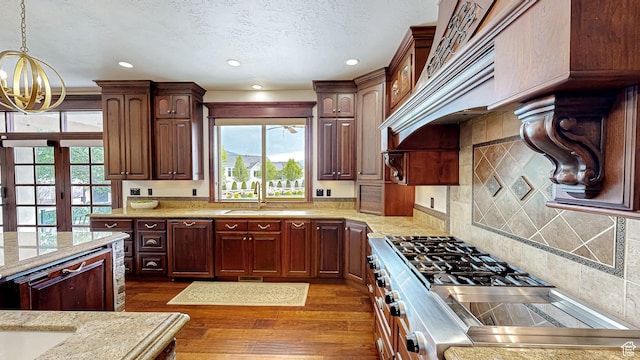 997 W 675 S, Mapleton, UT 84664 - kitchen featuring a chandelier, a sink, dark wood-style flooring, decorative light fixtures, and light stone counters