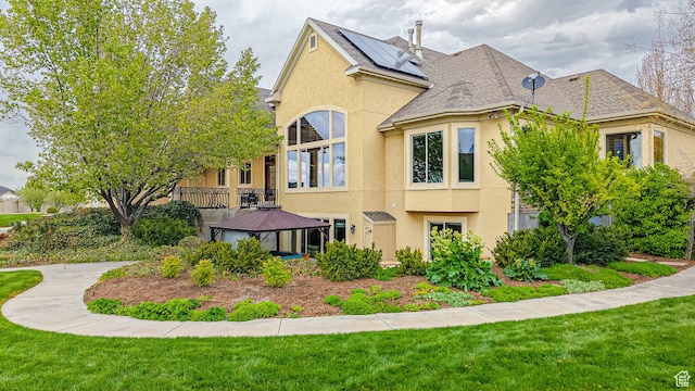 997 W 675 S, Mapleton, UT 84664 - view of home's exterior featuring stucco siding, a gazebo, a lawn, and a shingled roof