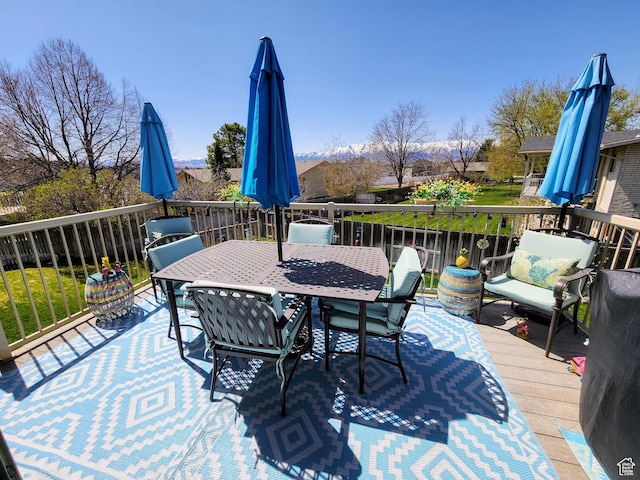 wooden terrace featuring outdoor dining space