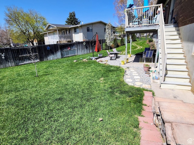 view of yard featuring stairway and a patio