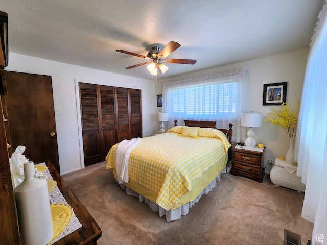 carpeted bedroom with a closet and a ceiling fan