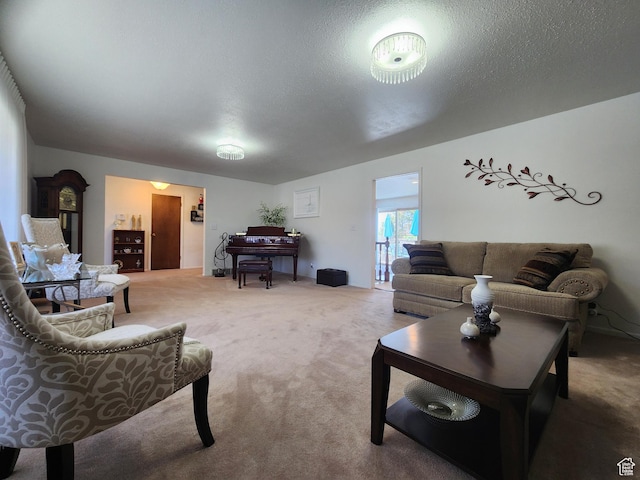 living room featuring carpet and a textured ceiling