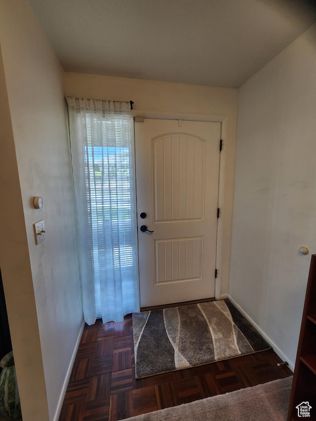 doorway to outside with baseboards