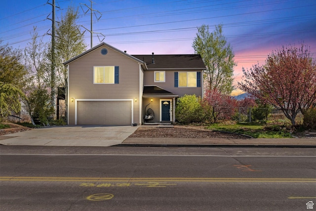view of front facade with an attached garage, fence, and driveway