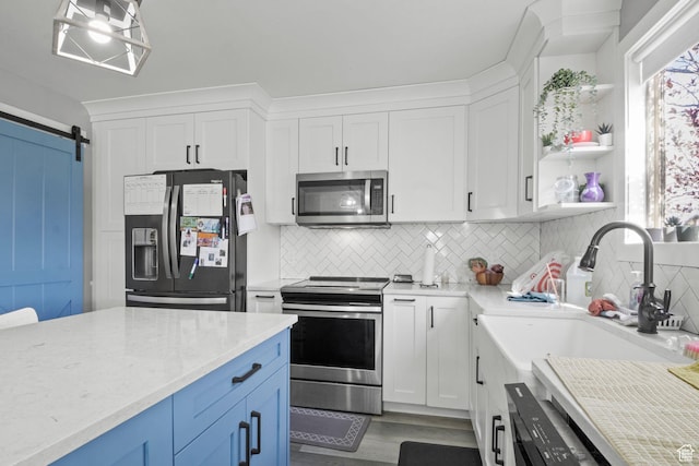 1635 W 700 S, Lehi, UT 84043 - kitchen featuring a barn door, appliances with stainless steel finishes, white cabinetry, and wood finished floors