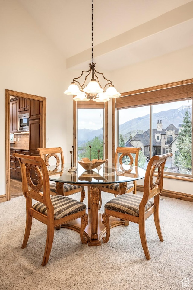 1263 E Wild Maple Ct, Draper, UT 84020 - dining room featuring light colored carpet, a towering ceiling, baseboards, a mountain view, and a chandelier