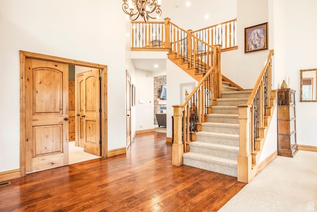 1263 E Wild Maple Ct, Draper, UT 84020 - stairway with an inviting chandelier, baseboards, a high ceiling, and hardwood / wood-style flooring
