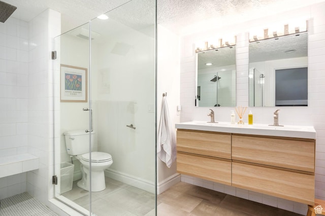 1263 E Wild Maple Ct, Draper, UT 84020 - bathroom with double vanity, a shower stall, a textured ceiling, and a sink