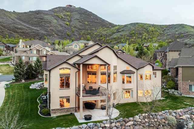 1263 E Wild Maple Ct, Draper, UT 84020 - back of house with stucco siding, a mountain view, a patio area, a balcony, and a yard