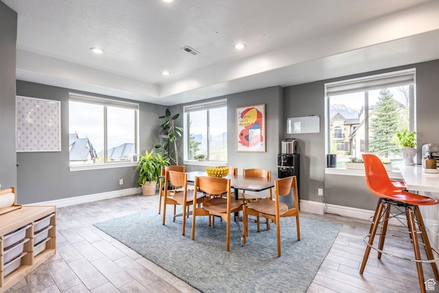 1263 E Wild Maple Ct, Draper, UT 84020 - dining area with a tray ceiling, visible vents, plenty of natural light, and light wood-type flooring