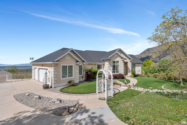 110 W Oak Cir, Woodland Hills, UT 84653 - ranch-style home featuring stucco siding, a front lawn, a mountain view, and concrete driveway