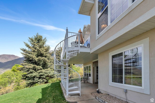 110 W Oak Cir, Woodland Hills, UT 84653 - view of property exterior with a balcony, stucco siding, a patio area, a lawn, and stairway