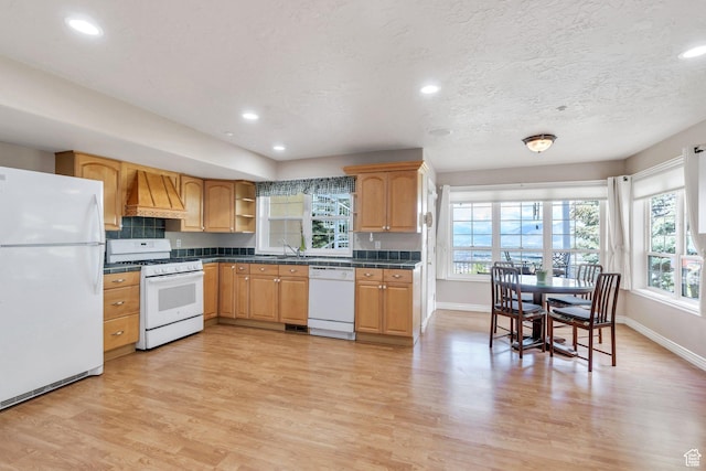 110 W Oak Cir, Woodland Hills, UT 84653 - kitchen with dark countertops, white appliances, baseboards, custom range hood, and light wood finished floors