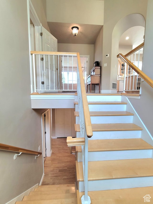 110 W Oak Cir, Woodland Hills, UT 84653 - stairway featuring visible vents, arched walkways, and wood finished floors