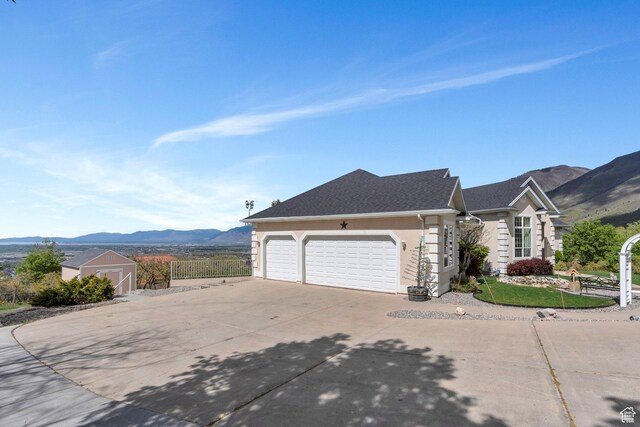 110 W Oak Cir, Woodland Hills, UT 84653 - view of front of house featuring a garage, a mountain view, stucco siding, and concrete driveway