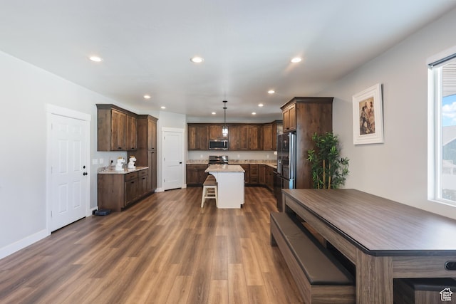 1167 N 150 E Unit 53, Nephi, UT 84648 - kitchen featuring a kitchen breakfast bar, recessed lighting, dark wood-type flooring, a center island, and stainless steel appliances