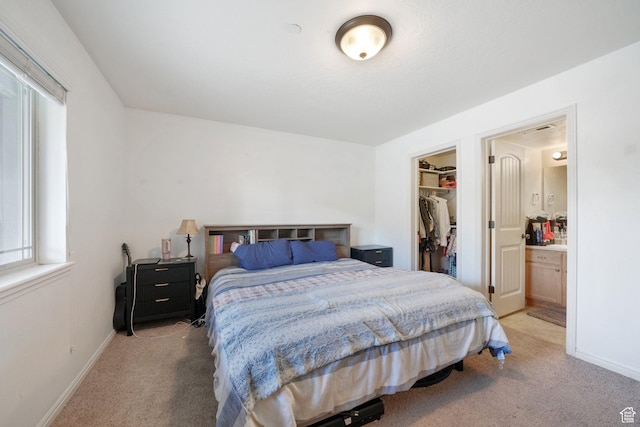 3569 E Rock Creek Rd Unit G2, Eagle Mountain, UT 84005 - bedroom featuring a walk in closet, baseboards, a closet, and light colored carpet