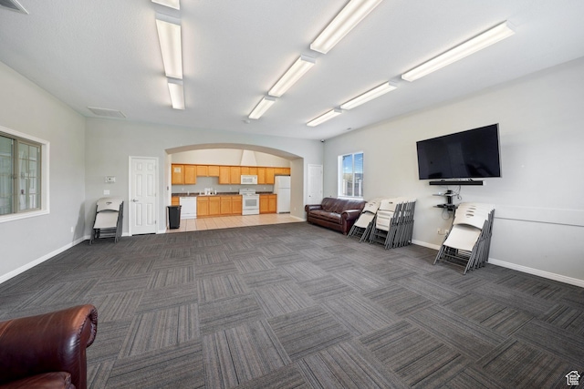 3569 E Rock Creek Rd Unit G2, Eagle Mountain, UT 84005 - interior space with dark colored carpet, arched walkways, and baseboards