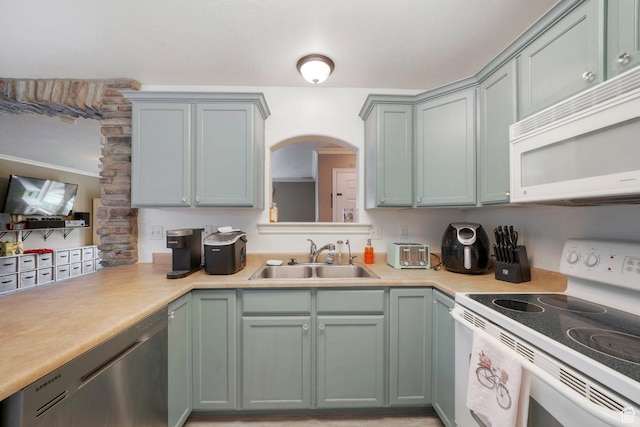 3569 E Rock Creek Rd Unit G2, Eagle Mountain, UT 84005 - kitchen featuring white appliances, arched walkways, a sink, and light countertops