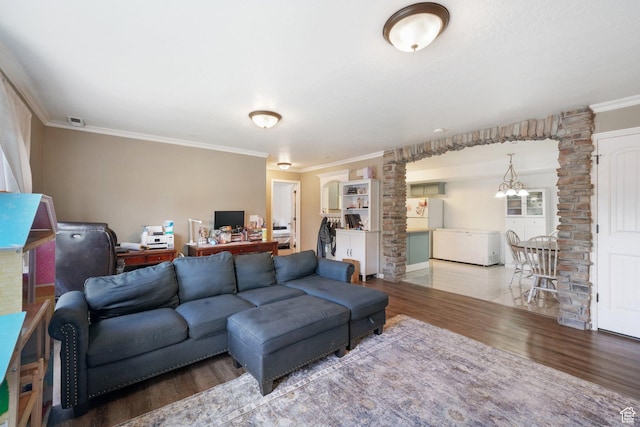 3569 E Rock Creek Rd Unit G2, Eagle Mountain, UT 84005 - living room with crown molding, ornate columns, an inviting chandelier, and wood finished floors
