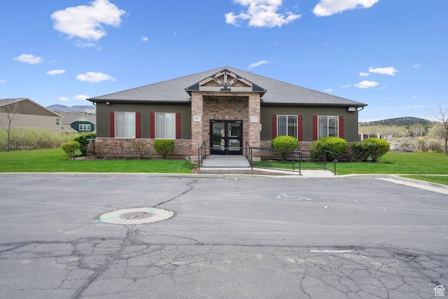 3569 E Rock Creek Rd Unit G2, Eagle Mountain, UT 84005 - view of front of house with french doors, a front yard, uncovered parking, stone siding, and stucco siding