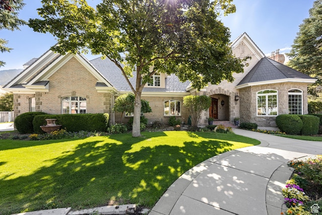 566 N Bella Vista Dr E, Orem, UT 84097 - view of front facade featuring stone siding, a front lawn, and brick siding