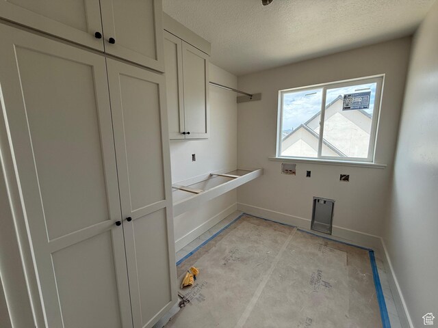 4097 N Ophir Dr, Eagle Mountain, UT 84005 - washroom with a textured ceiling, washer hookup, and cabinet space
