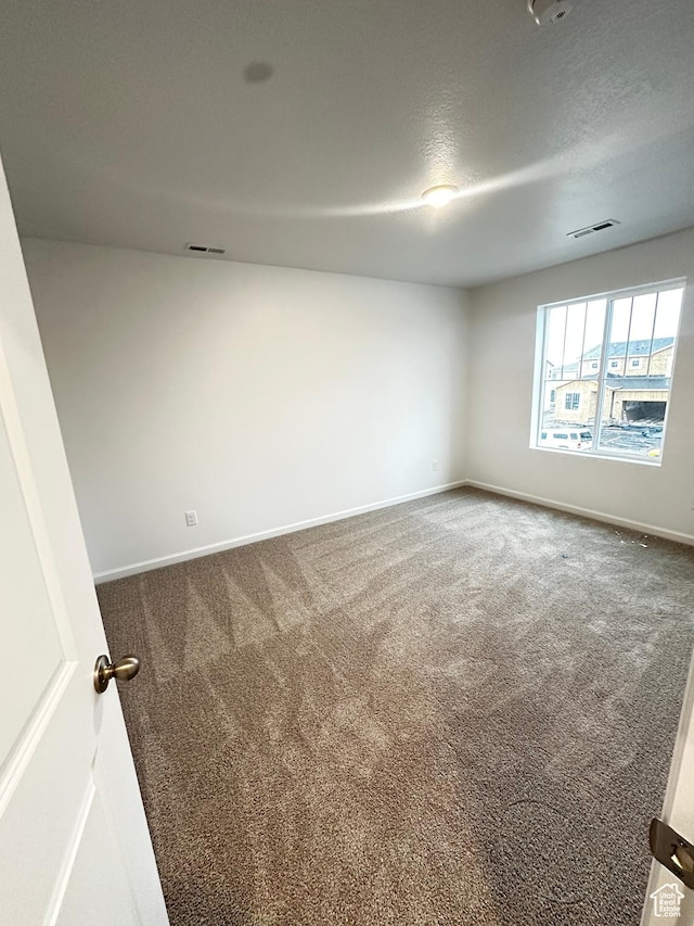 1071 W 400 S Unit 44, Brigham City, UT 84302 - carpeted empty room with baseboards and a textured ceiling