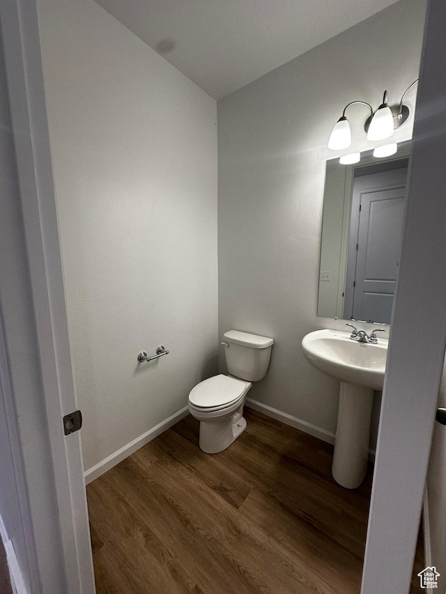 1071 W 400 S Unit 44, Brigham City, UT 84302 - half bathroom featuring wood finished floors, toilet, and baseboards