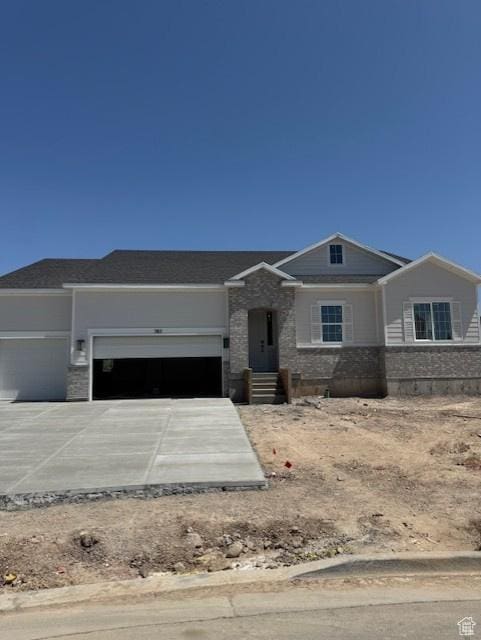 382 W 1225 N Unit 2, Harrisville, UT 84404 - view of front of house featuring an attached garage, stone siding, and concrete driveway