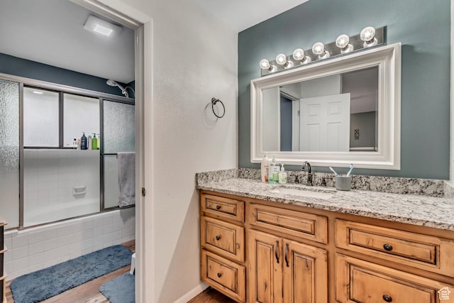 239 Country Club Dr, Stansbury Park, UT 84074 - bathroom with tiled shower / bath, vanity, and wood finished floors