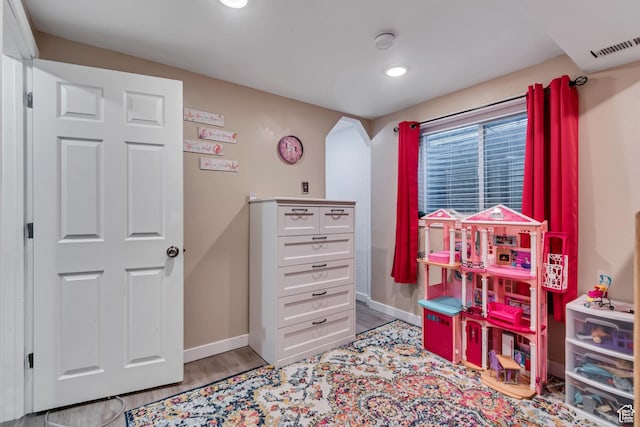 239 Country Club Dr, Stansbury Park, UT 84074 - game room featuring wood finished floors, baseboards, arched walkways, and recessed lighting