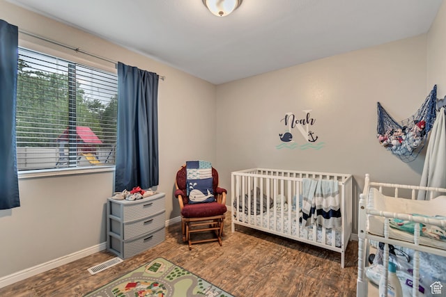 239 Country Club Dr, Stansbury Park, UT 84074 - bedroom featuring wood finished floors, baseboards, and a nursery area