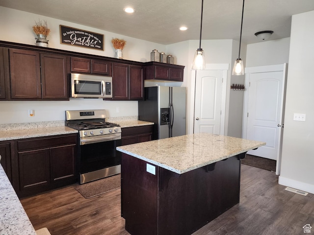 113 N Granite Park Dr, Saratoga Springs, UT 84045 - kitchen with stainless steel appliances, dark wood-style floors, dark brown cabinetry, a center island, and recessed lighting