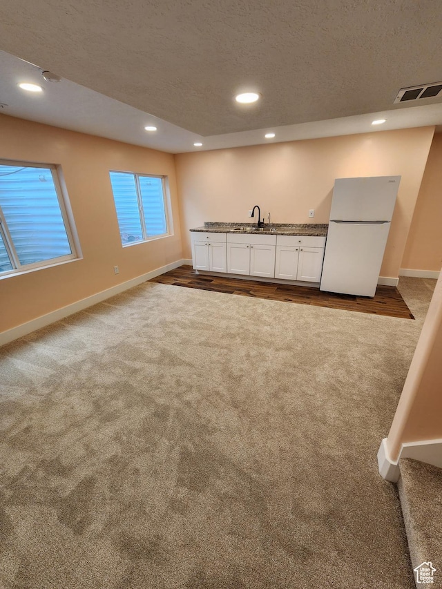 113 N Granite Park Dr, Saratoga Springs, UT 84045 - kitchen featuring freestanding refrigerator, dark carpet, baseboards, recessed lighting, and white cabinetry