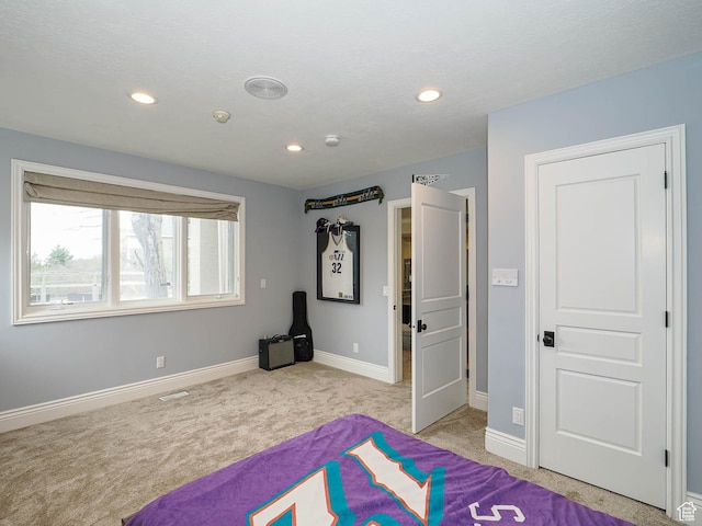 unfurnished bedroom with baseboards, recessed lighting, visible vents, and light carpet