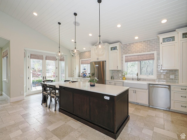 kitchen featuring stone tile floors, recessed lighting, appliances with stainless steel finishes, and a sink
