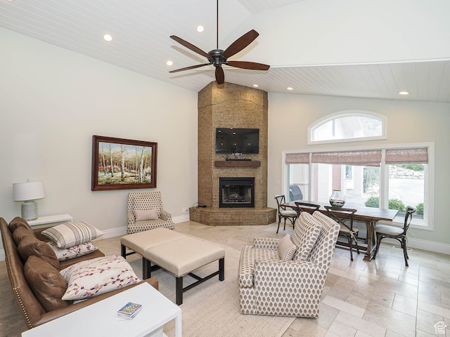 living area with a ceiling fan, a large fireplace, high vaulted ceiling, baseboards, and recessed lighting
