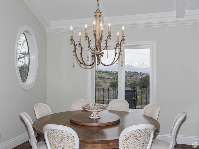 dining room featuring crown molding, baseboards, a notable chandelier, and a healthy amount of sunlight