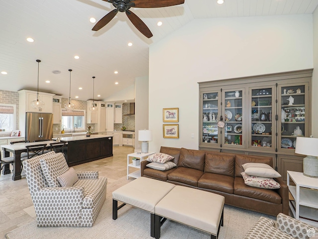living area with recessed lighting, ceiling fan, and high vaulted ceiling