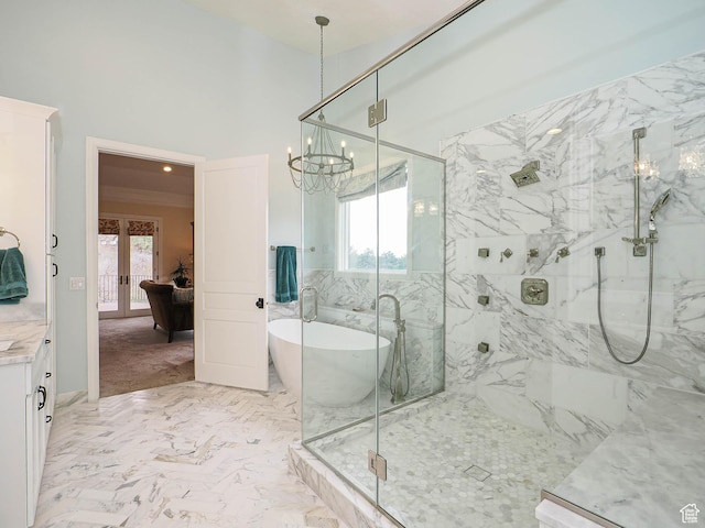 full bathroom with french doors, a marble finish shower, a notable chandelier, and a healthy amount of sunlight