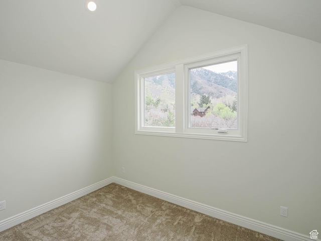 bonus room with carpet flooring, baseboards, and vaulted ceiling