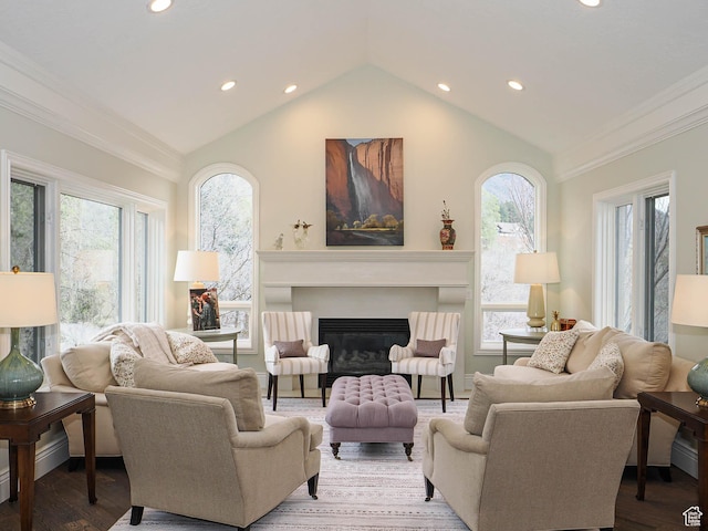 living area featuring recessed lighting, crown molding, lofted ceiling, and a healthy amount of sunlight