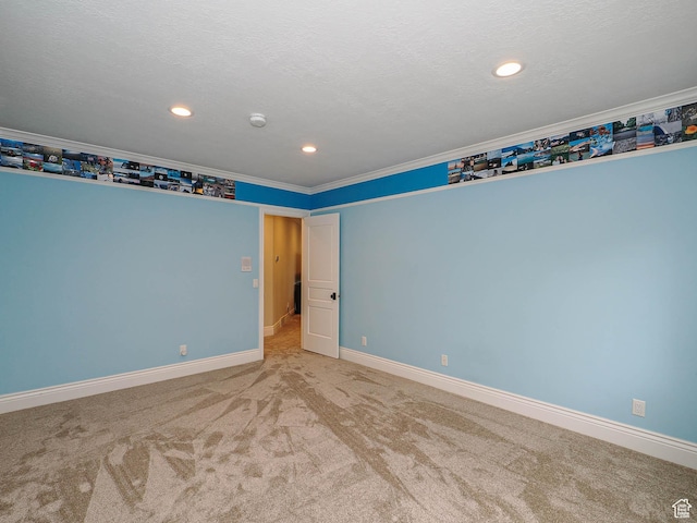 carpeted empty room with baseboards, ornamental molding, and recessed lighting