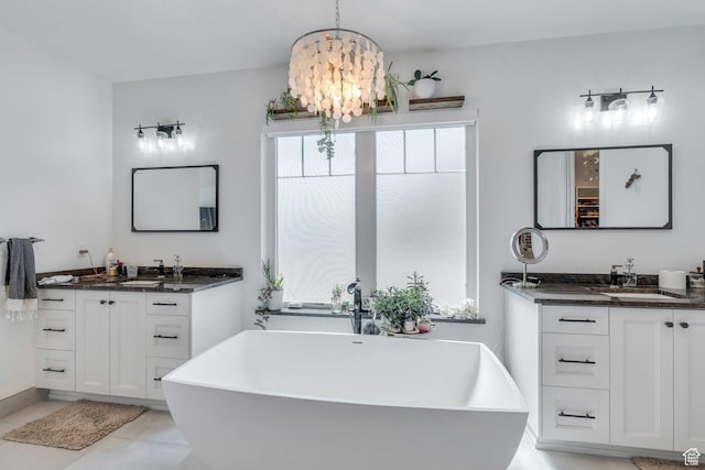 654 N 200 E, American Fork, UT 84003 - bathroom featuring a freestanding tub, two vanities, a sink, tile patterned floors, and a chandelier