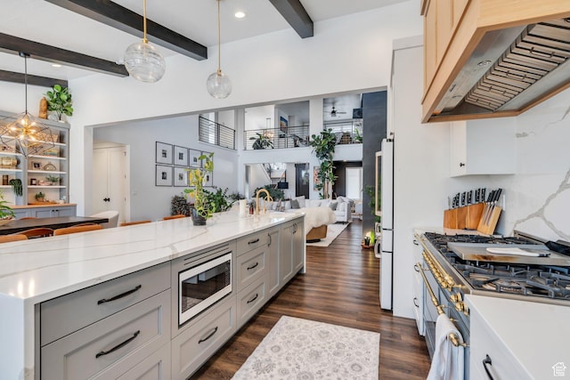 654 N 200 E, American Fork, UT 84003 - kitchen with dark wood-style flooring, extractor fan, stainless steel microwave, open floor plan, and beamed ceiling